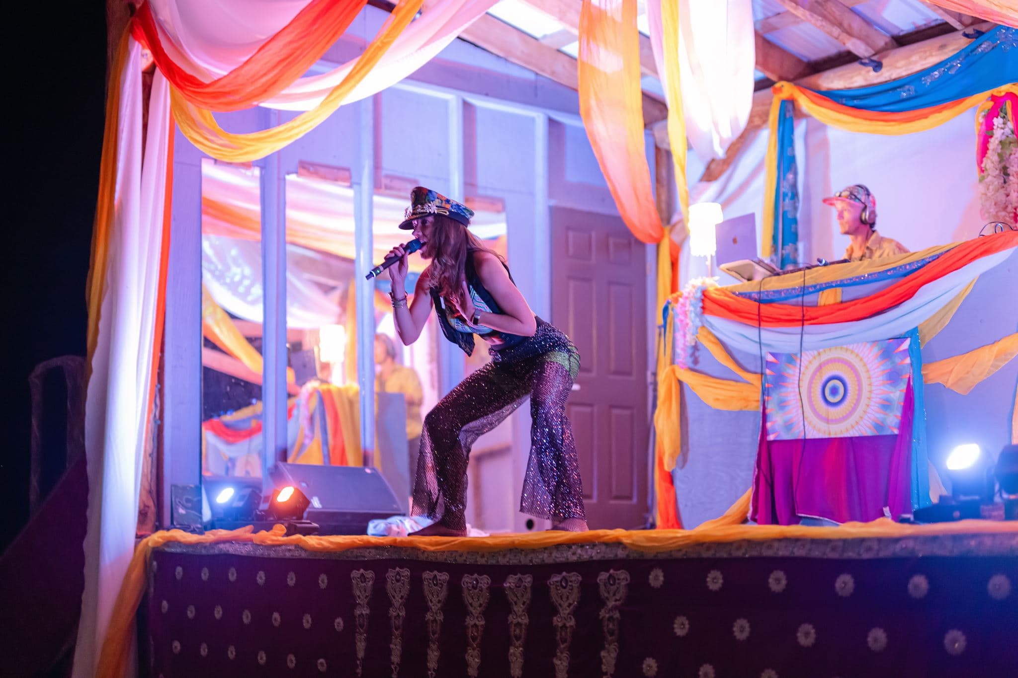 Lara Brightside leaning toward the audience while performing.